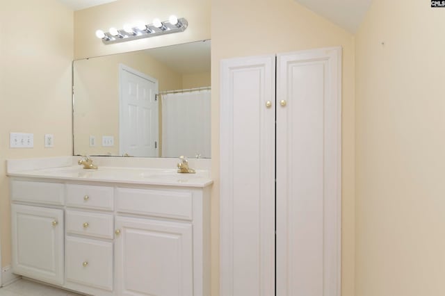 bathroom with vanity and lofted ceiling