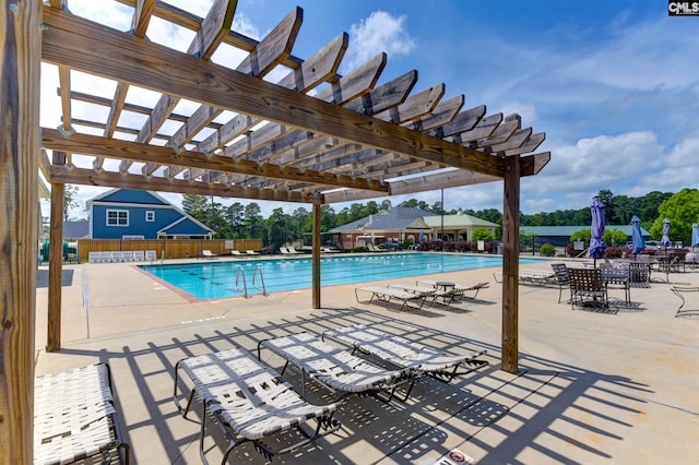 view of pool with a patio and a pergola