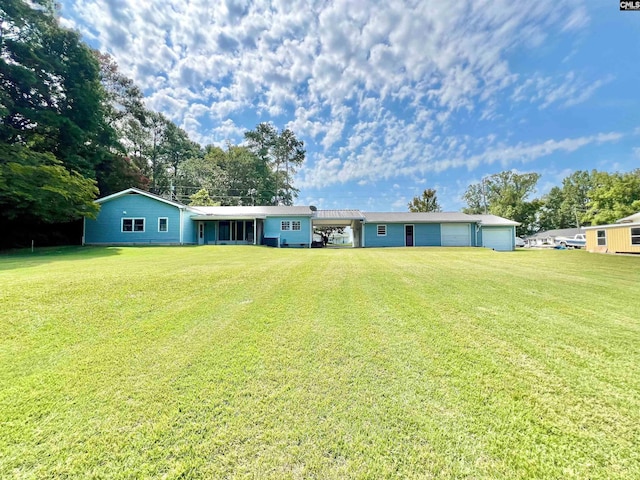 view of front of home with a garage and a front lawn