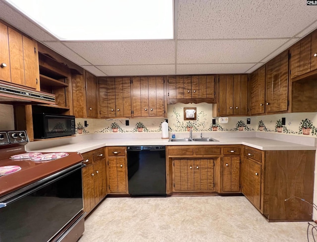 kitchen featuring open shelves, a sink, light countertops, brown cabinets, and black appliances