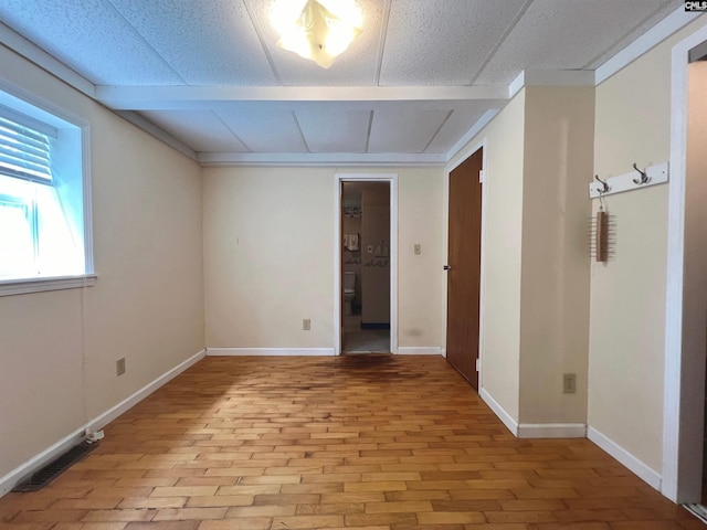 unfurnished room with baseboards and visible vents