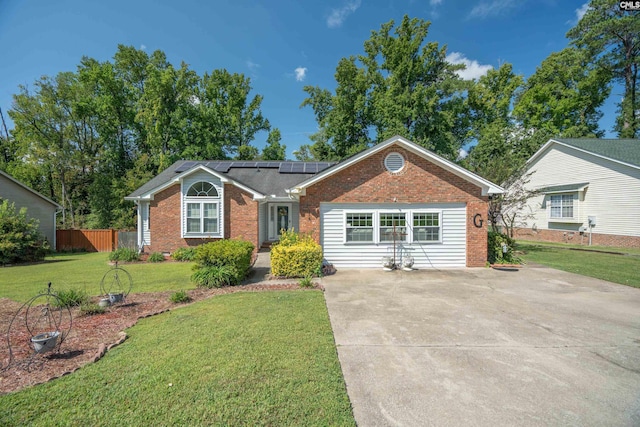 ranch-style home featuring solar panels and a front lawn