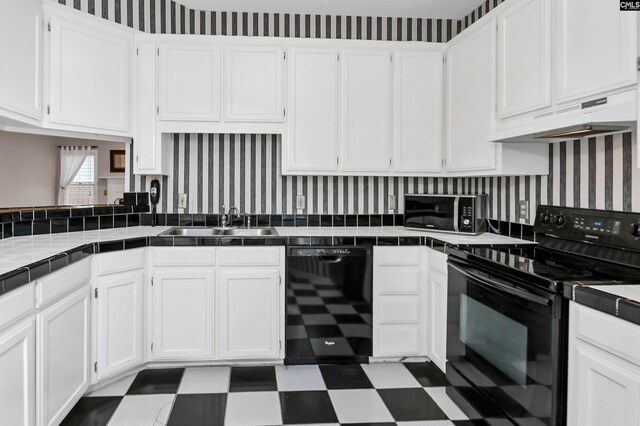 kitchen featuring black appliances, tile countertops, and white cabinets