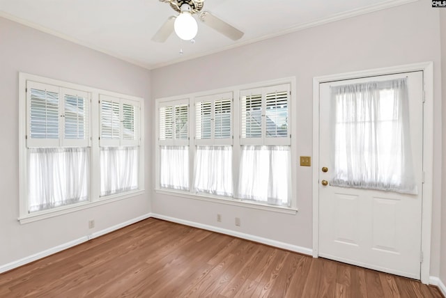 interior space featuring crown molding, hardwood / wood-style flooring, a wealth of natural light, and ceiling fan