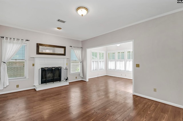 unfurnished living room with dark hardwood / wood-style floors and crown molding