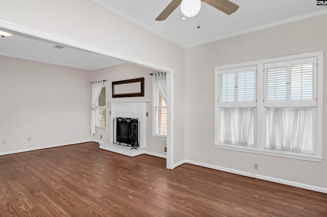 unfurnished living room featuring dark wood-type flooring, ceiling fan, and ornamental molding