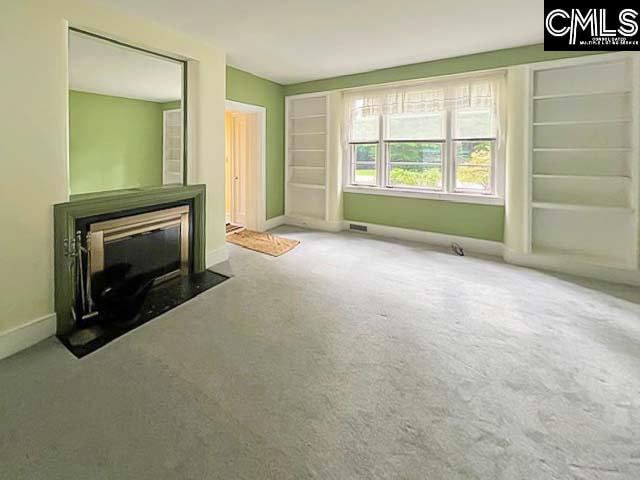 unfurnished living room with carpet floors