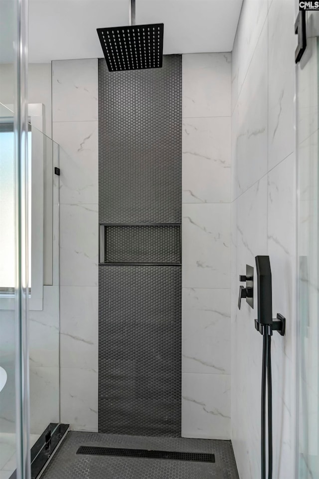 bathroom with a tile shower