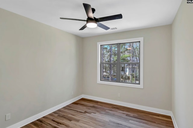 empty room with ceiling fan and light hardwood / wood-style flooring