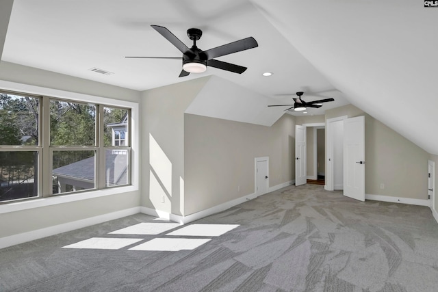 additional living space with light carpet, lofted ceiling, and ceiling fan