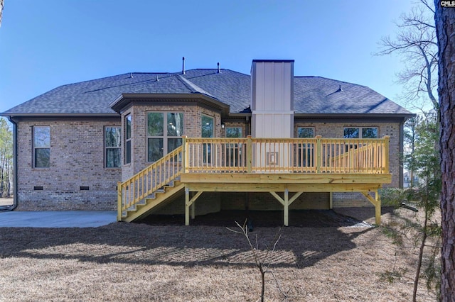 rear view of property featuring a deck