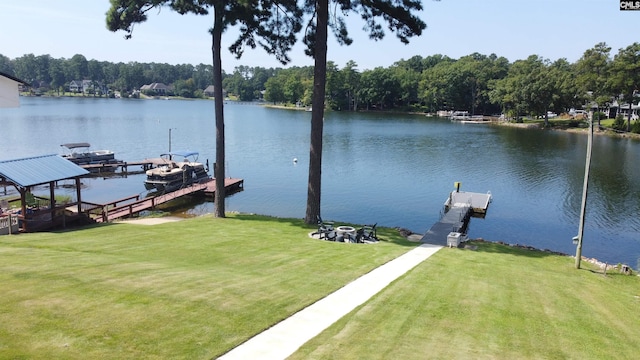 view of dock with a water view and a lawn