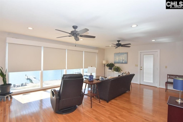 living room with hardwood / wood-style floors and ceiling fan