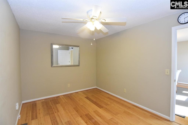 empty room with ceiling fan, light hardwood / wood-style floors, and a textured ceiling