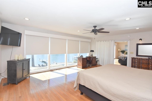 bedroom with light hardwood / wood-style flooring, ceiling fan, and access to outside