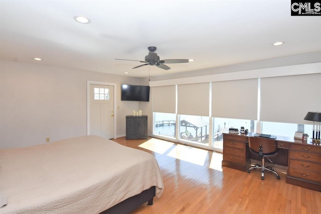 bedroom with light wood-type flooring, ceiling fan, and access to exterior