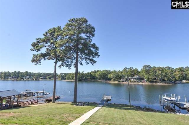 view of dock featuring a lawn and a water view