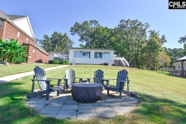 exterior space with an outdoor fire pit and a patio