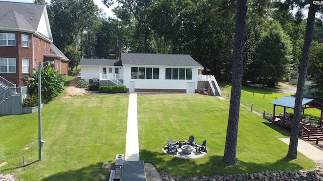 view of front facade featuring a gazebo, an outdoor fire pit, and a front yard