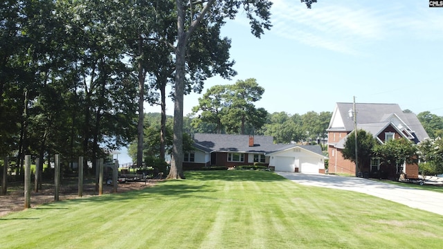 view of front of home with a garage and a front lawn