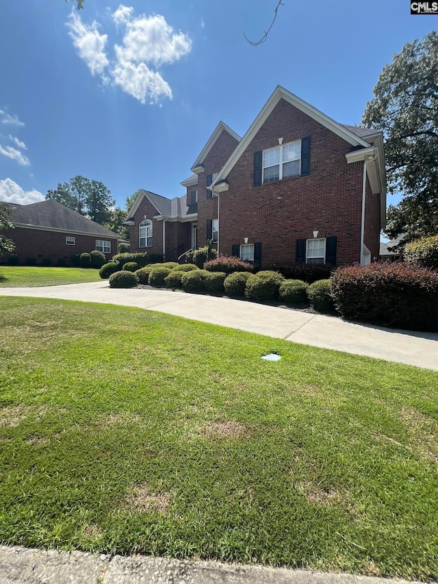 view of front of house featuring a front yard and cooling unit