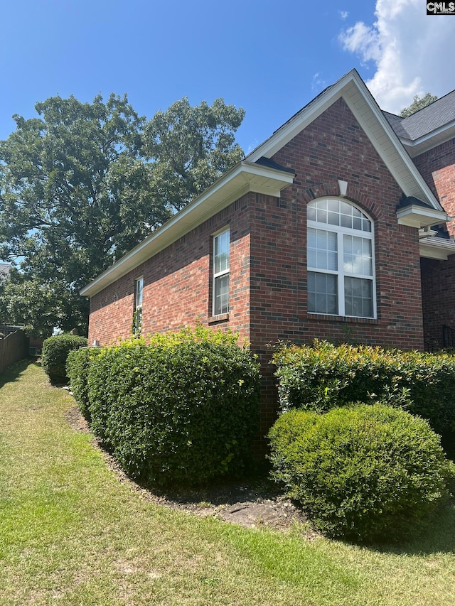 view of side of property with a yard