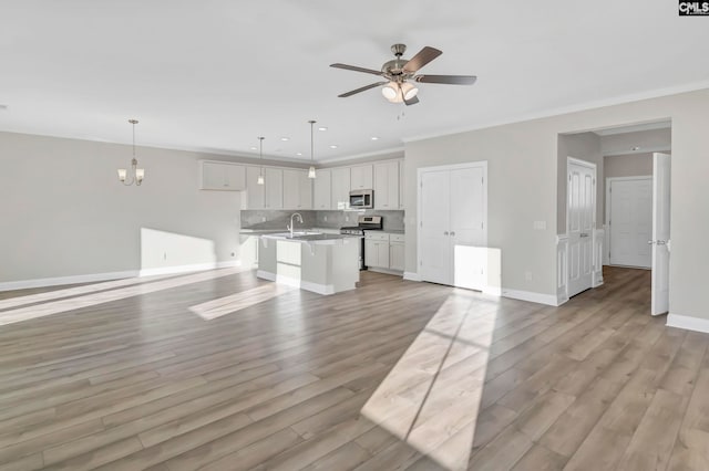 unfurnished living room with crown molding, light hardwood / wood-style flooring, and ceiling fan