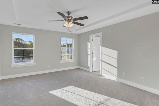 carpeted spare room with ceiling fan