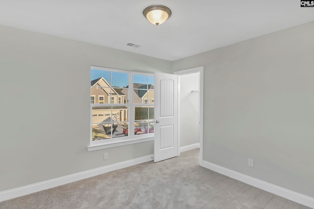 unfurnished room with light colored carpet