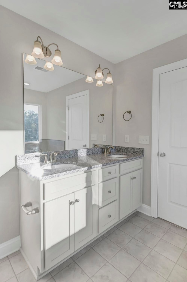 bathroom featuring tile patterned flooring and vanity