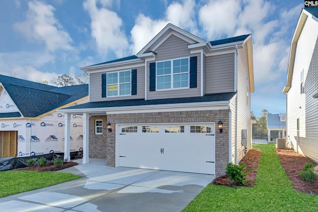 view of front of home with a garage and central AC unit