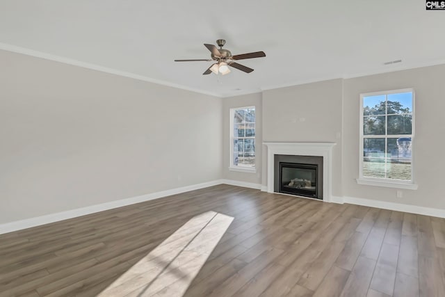 unfurnished living room featuring crown molding, wood-type flooring, and ceiling fan