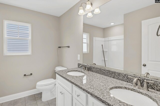 bathroom featuring tile patterned flooring, toilet, and vanity