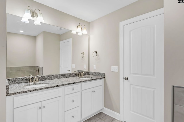 bathroom featuring vanity, a bathing tub, and tile patterned floors