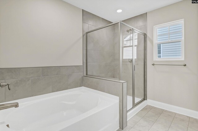 bathroom featuring tile patterned flooring and independent shower and bath