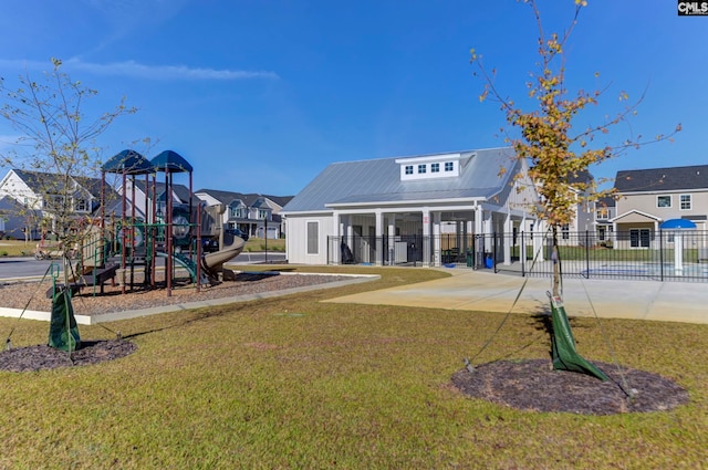 view of playground with a lawn