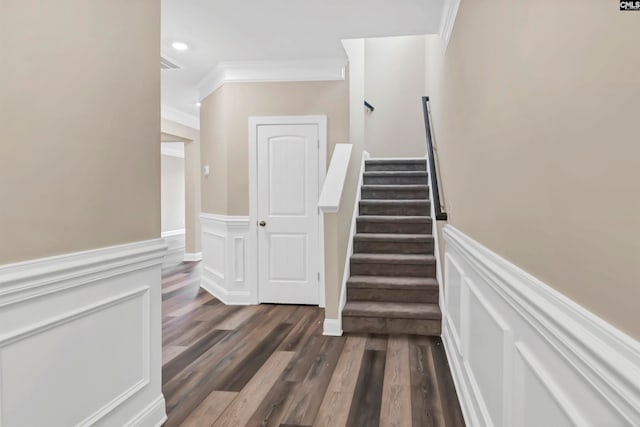 stairway featuring ornamental molding and hardwood / wood-style floors