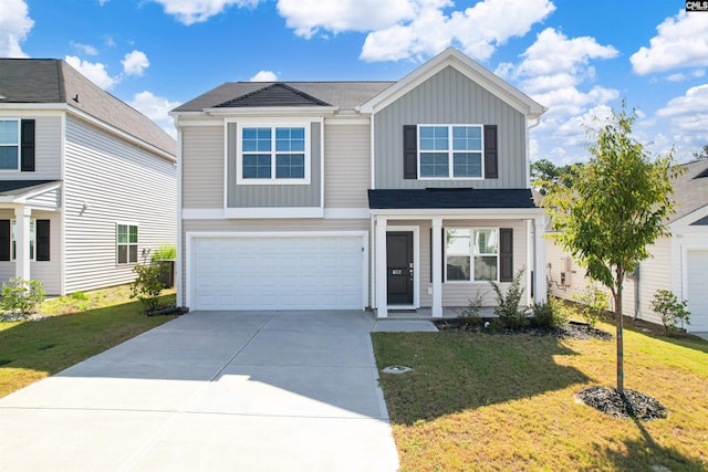 view of front of property with a garage and a front lawn