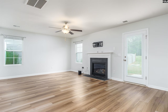 unfurnished living room featuring light wood-type flooring and ceiling fan