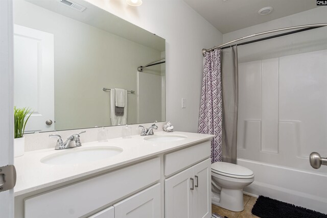 full bathroom with vanity, toilet, tile patterned floors, and shower / bath combo with shower curtain