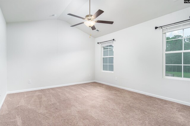 empty room featuring light colored carpet, lofted ceiling, and ceiling fan