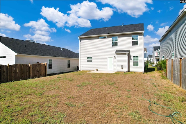 rear view of house featuring a lawn