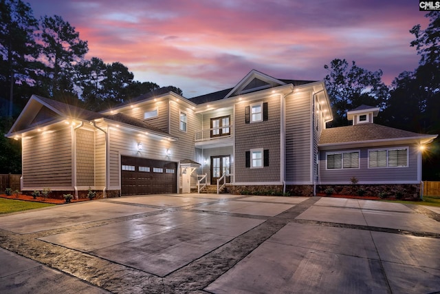 view of front of house featuring concrete driveway, french doors, and a garage