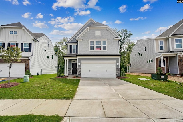 craftsman-style house with a garage and a front lawn