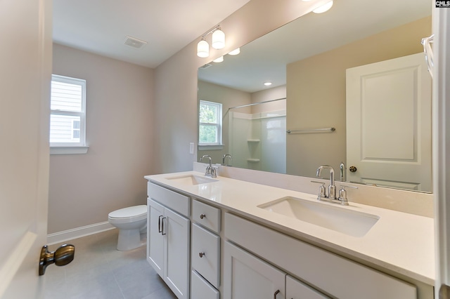 bathroom featuring vanity, toilet, a shower, and tile patterned flooring