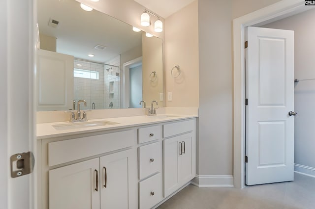 bathroom featuring a shower with door and vanity