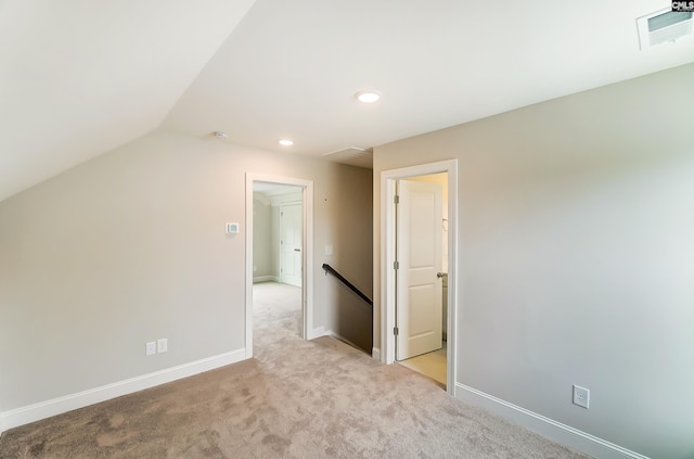 bonus room featuring light carpet and lofted ceiling