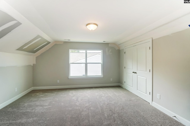 bonus room featuring lofted ceiling and carpet floors