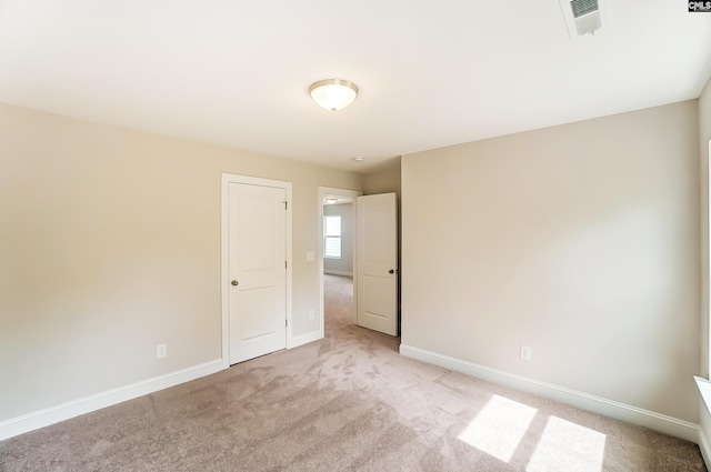 unfurnished bedroom featuring light carpet