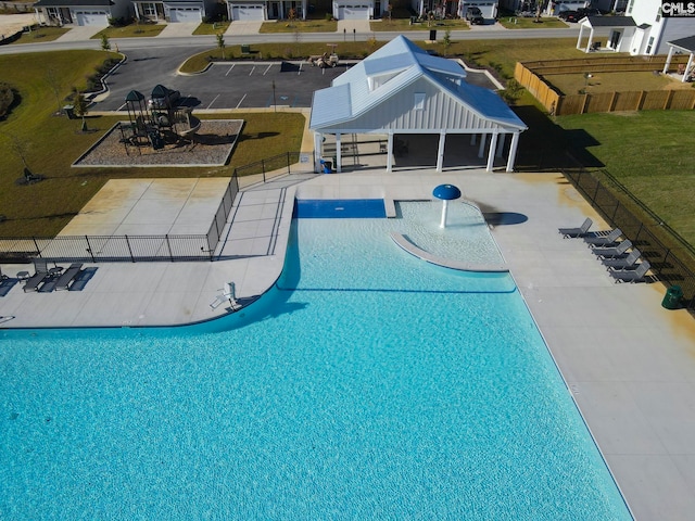 view of pool featuring a lawn and a patio area